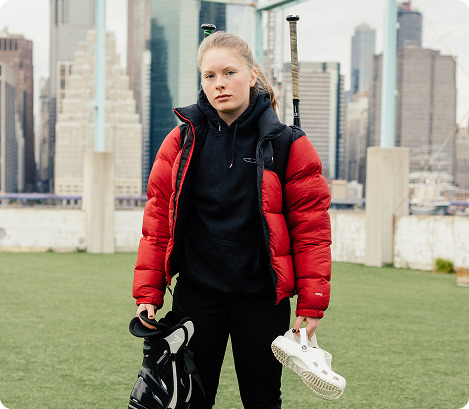 A softball player standing on the field